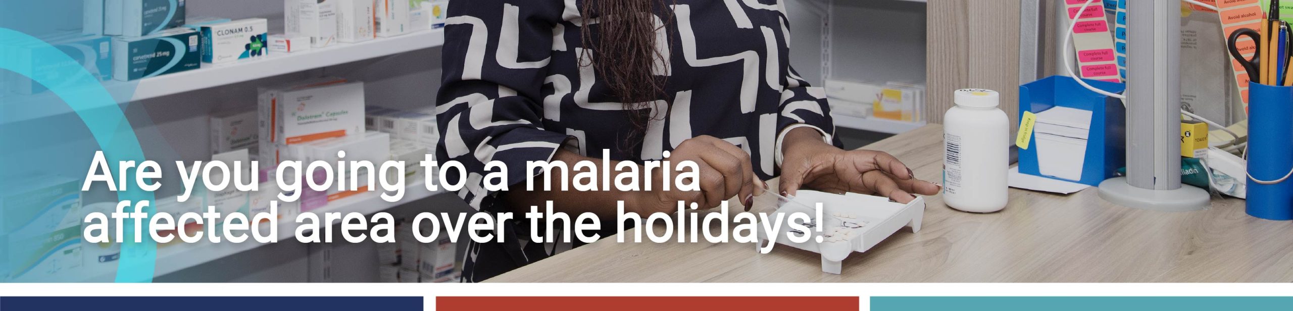 Pharmacist preparing medication in a clinic dispensary with shelves of chronic medication in the background.